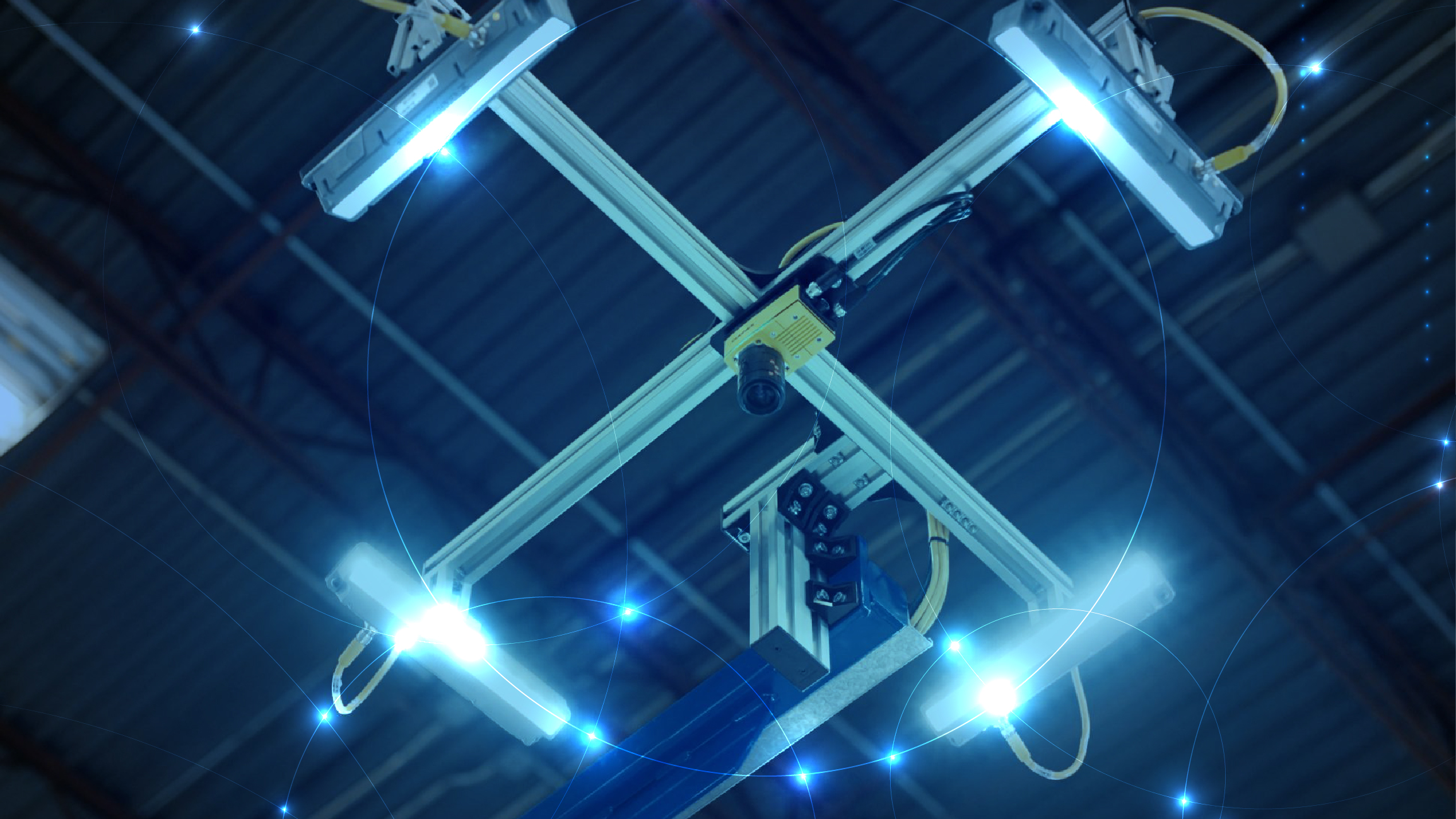 A cobot with vision capabilities hangs above an assembly line.